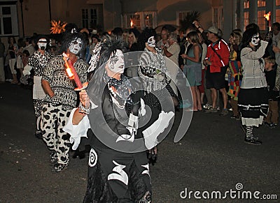 SIDMOUTH, DEVON, ENGLAND - AUGUST 10TH 2012: A dance troup dressed in very eerie black and white costumes take part in the night Editorial Stock Photo