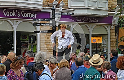 SIDMOUTH, DEVON, ENGLAND - AUGUST 5TH 2012: Two street jugglers and entertainers perform in the town square to an appreciative Editorial Stock Photo