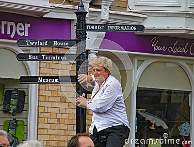 SIDMOUTH, DEVON, ENGLAND - AUGUST 5TH 2012: Two street jugglers and entertainers perform in the town square to an appreciative Editorial Stock Photo