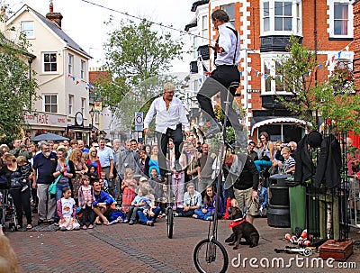 SIDMOUTH, DEVON, ENGLAND - AUGUST 5TH 2012: Two street jugglers and entertainers perform in the town square to an appreciative Editorial Stock Photo