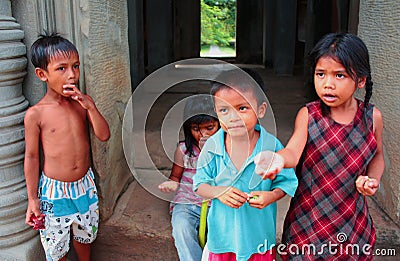 Cambodian children begging for some candy at the temple Editorial Stock Photo