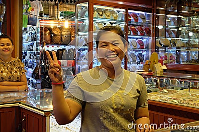 Asian woman smiling and gesturing, jewelry seller Editorial Stock Photo