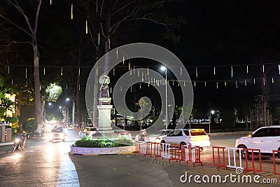 Cars drive through the night city. Naga sculpture. Street decorations with neon lights Editorial Stock Photo