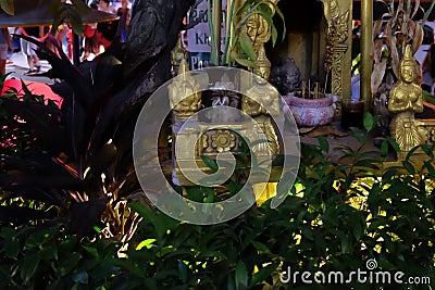 Small Hindu sanctuary on the street of an Asian city, night time Editorial Stock Photo