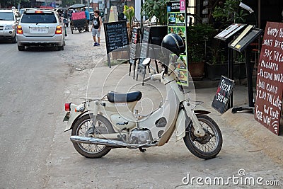 Small white moped near the pizzeria Editorial Stock Photo