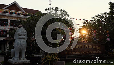 White stone sculpture of a lion and festive scenery near the entrance to an Asian hotel. Editorial Stock Photo