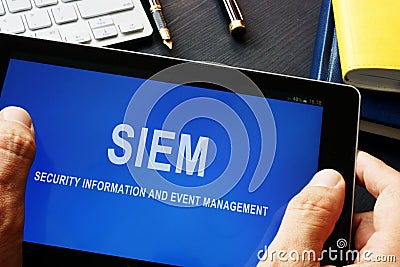 SIEM Security information and event management program in a tablet. Stock Photo