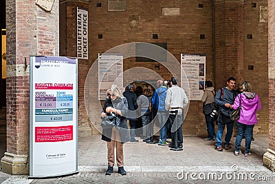 Queue to purchase a ticket at the ticket office to visit the Palazzo Pubblico in Siena, Italy Editorial Stock Photo