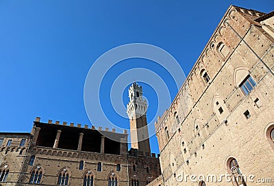 Siena, SI, Italy - February 20, 2023: High Tower called Torre del Mangia and ancient palaces Editorial Stock Photo