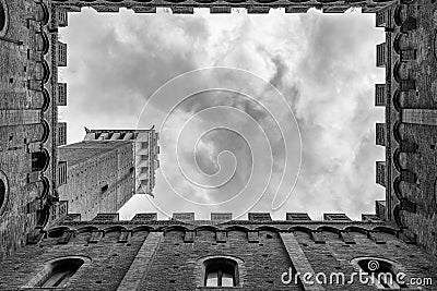 Siena Tower - Looking up towards Torre del Mangia Mangia tower from inside of Palazzo Publico inner courtyard in Siena, Tuscany Editorial Stock Photo