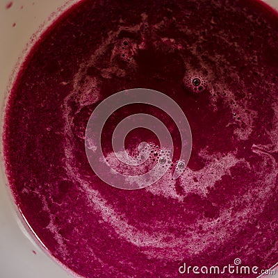 Sieving raspberry puree Stock Photo