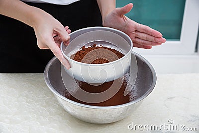 Sifting cocoa powder Stock Photo