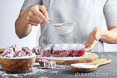 Sifting confectioners sugar on top of a dessert Stock Photo