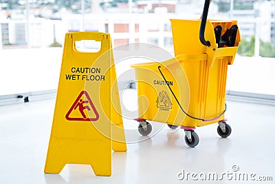 Sigh board with mop bucket in room Stock Photo