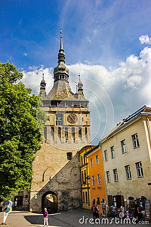 Sighisoara - The famous Sighisoara Clock Tower with people passing by Editorial Stock Photo