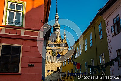 Sighisoara, Romania: Old building in Sighisoara citadel. Tower Clock in Sighisoara Editorial Stock Photo