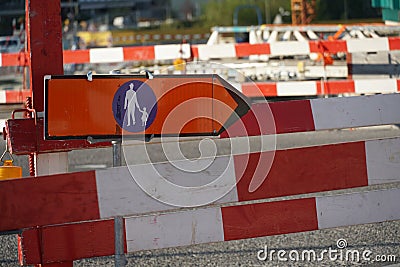 Sign for alternate route or deviation for pedestrian close up in a complex civil engineering site marked with many barrier planks Stock Photo