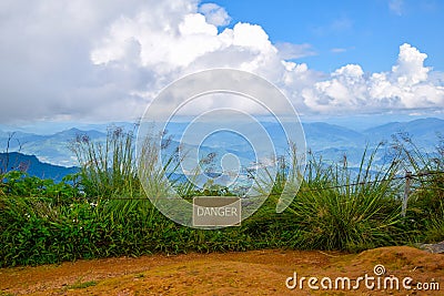 A sign attached to the wire showing the word "dangerous" Stock Photo