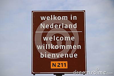 Sign on the border in 4 languages to welcome travelers in the Netherlands at the ferry of Hoek van Holland. Editorial Stock Photo