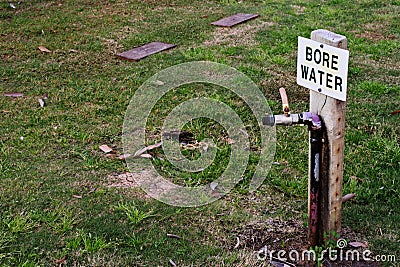 A sign for bore water in the midst of a dried out lawn. Stock Photo
