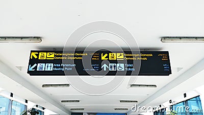 Sign direction at the Indonesian Airport, Translate in english: Domestic departures, Domestic Arrivals, Meeting point, and Toilets Editorial Stock Photo