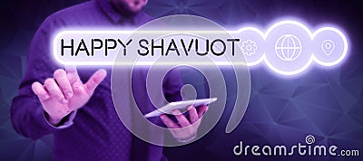 Sign displaying Happy Shavuot. Word for Jewish holiday commemorating of the revelation of the Ten Commandments Stock Photo