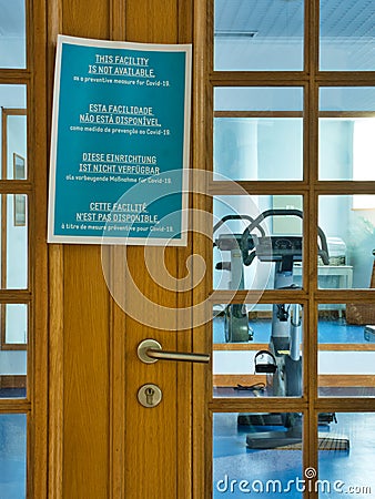 A sign in English, Portuguese, German and French advises that gym facilities are closed as part of the coronavirus lockdown Editorial Stock Photo