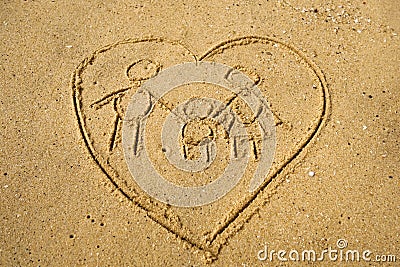 Sign of family inside heart shape frawn on beach Stock Photo