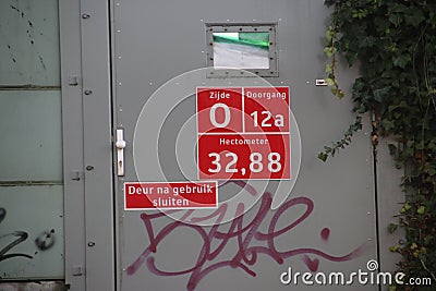 Sign for firefighters, paramedics and police where and which entrance it is to busy railroad track at Zwijndrecht. Editorial Stock Photo