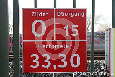 Sign for firefighters, paramedics and police where and which entrance it is to busy railroad track at Zwijndrecht. Editorial Stock Photo