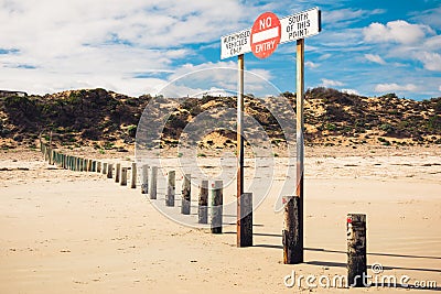 A sign forbidding entry to the beach by unauthorized cars Stock Photo
