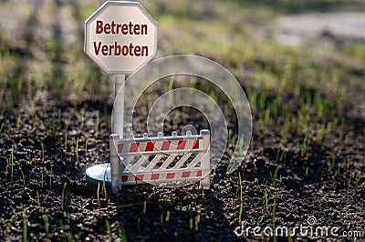 A sign with the German text `betreten verboten` keep off on a new lawn. Stock Photo