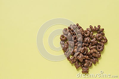 Sign of the heart of the dry Breakfast cereal in the form of letters of the alphabet, chocolate flakes useful food for children, Stock Photo