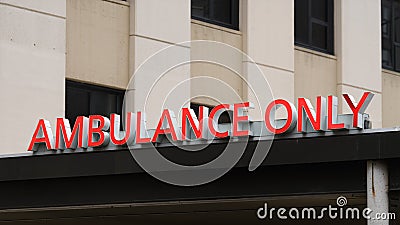 Sign at hospital for Ambulance Only entrance in red letters Editorial Stock Photo