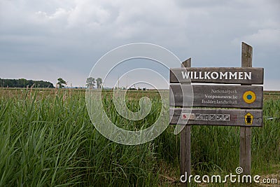 A sign with the inscription `Welcome National Park Vorpommersche Boddenlandschaft` Editorial Stock Photo