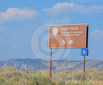 The sign for Lake Fork states it is part of the Curecanti National Recreation Area at Blue Mesa Reservoir and it is handicapped ac Stock Photo