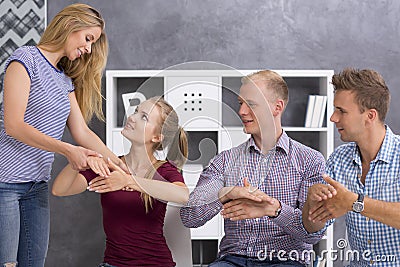 Sign language teacher correcting her students Stock Photo