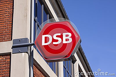 Sign with logo for DSB - abbreviation of Danske Statsbaner Danish State Railways, is the largest Danish train operating company Editorial Stock Photo