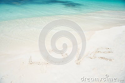 Sign love at sand beach with ocean wave crystal turquoise water. Romantic place perfect date or propose. Sand beach Stock Photo