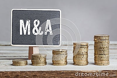 Sign Mergers and Acquisitions with growth coin stacks Stock Photo
