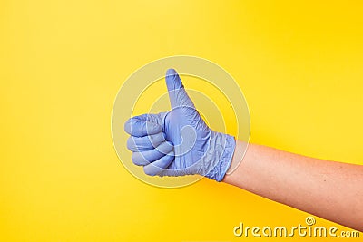 Sign OK made of woman`s hand in rubber protective glove. Stock Photo