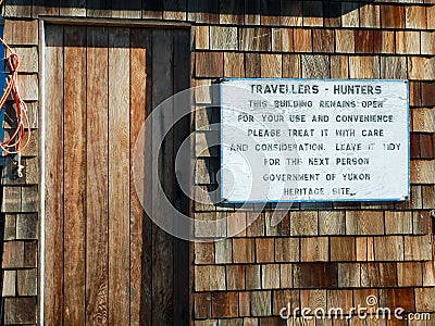 Sign outside hunting cabin, Herschel Island, Canada Stock Photo