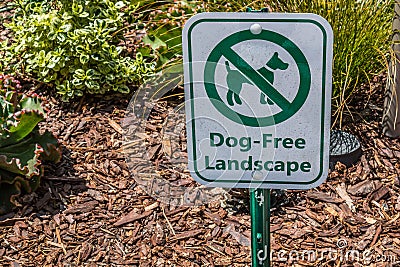 Sign Posted to Prohibit Access of Dogs on Landscaping Stock Photo