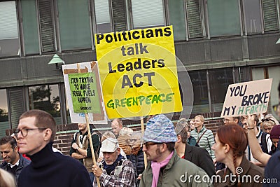 A sign reads Politicians talk Leaders ACT. The people s Climate March Editorial Stock Photo