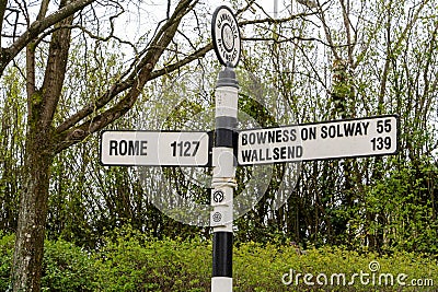 Sign showing distance and direction to Rome and Roman era historic sites in the area. Ravenglass UK Editorial Stock Photo