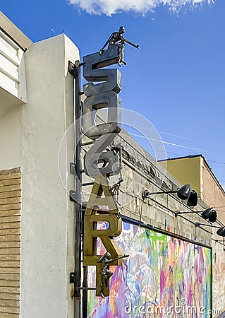 Sign with small human-like sculptures for 506 Art on Main Street on the square in downtown Garland, Texas. Editorial Stock Photo