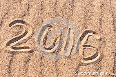 Sign 2016 and sun written on sandy beach. Summer travel concept Stock Photo