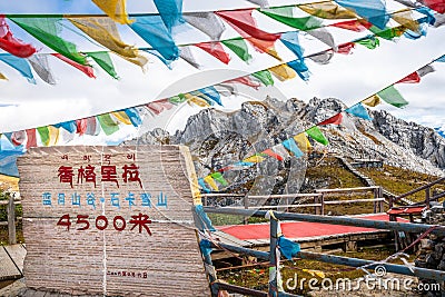 Sign and view of the 4500m high Shika snow mountain summit in Shangri-La Yunnan China translation : Blue moon valley Shika snow Stock Photo