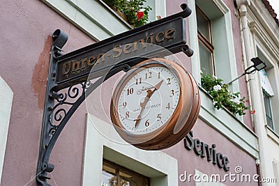 A sign `Watch and clock repairs` in the historical part of the city Alt Markt. Editorial Stock Photo