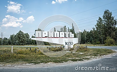 Sign welcoming visitors of dead city Pripyat text on sign: Pripyat 1970. Editorial Stock Photo